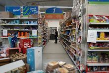 A shopper looks on shelves inside the Northern Store where most groceries and goods are purchased in Nain, N.L. on Friday, May 12, 2023. THE CANADIAN PRESS/Darren Calabrese