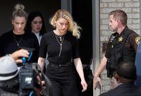 Amber Heard leaves Fairfax County Circuit Courthouse after the jury announced split verdicts in favor of both her ex-husband Johnny Depp and Heard on their claim and counter-claim in the Depp v. Heard civil defamation trial at the Fairfax County Circuit Courthouse in Fairfax, Virginia, U.S., June 1, 2022. REUTERS/Tom Brenner