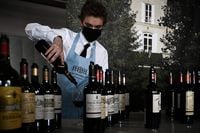 A man serves a glass of wine during the official 'Semaine des Primeurs' on April 25, 2022, in Bordeaux, southwestern France. - Organized by the 'Union des Grands Crus de Bordeaux' association (UGCB) the 'Semaine des Primeurs' runs until April 28, 2022 with presentations and tastings giving professionals and journalists the opportunity to discover the 2021 vintage. (Photo by Philippe LOPEZ / AFP) (Photo by PHILIPPE LOPEZ/AFP via Getty Images)