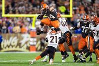 Oct 31, 2022; Cleveland, Ohio, USA; Cleveland Browns running back Nick Chubb (24) leaps over Cincinnati Bengals cornerback Mike Hilton (21) during the second quarter at FirstEnergy Stadium. Mandatory Credit: Scott Galvin-USA TODAY Sports