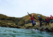 Domini Clark takes a leap into the Blue Lagoon in Pembrokeshire, Wales.