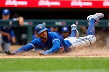 MINNEAPOLIS, MN - MAY 28: George Springer #4 of the Toronto Blue Jays slides into home plate to score a run in the eighth inning against the Minnesota Twins at Target Field on May 28, 2023 in Minneapolis, Minnesota. The Blue Jays defeated the Twins 3-0. (Photo by David Berding/Getty Images)