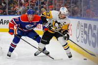 Oct 24, 2022; Edmonton, Alberta, CAN; Edmonton Oilers forward Connor McDavid (97) and Pittsburgh Penguins forward Sidney Crosby (87) battle along the boards for a loose puck during the second period at Rogers Place. Mandatory Credit: Perry Nelson-USA TODAY Sports
