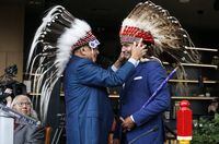 Manitoba Premier designate Wab Kinew, receives a War Bonnet from his uncle prior to a Premier and cabinet swearing-in ceremony in Winnipeg, Wednesday, Oct. 18, 2023. THE CANADIAN PRESS/John Woods