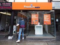 A man enters a Freedom Mobile store in Toronto on November 24, 2016. THE CANADIAN PRESS/Nathan Denette