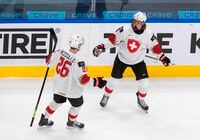 FILE - In this Dec. 27, 2020, file photo, Switzerland's Attilio Biasca (9) and Rocco Pezzullo (26) celebrate a goal during the first period IIHF World Junior Hockey Championship game against Finland in Edmonton, Alberta. The Under-18 men’s world championship that begins Monday is the final chance to see some of the top prospects eligible for the 2021 NHL draft, and the first chance for scouts and executives to see many in person. (Jason Franson/The Canadian Press via AP, File)
