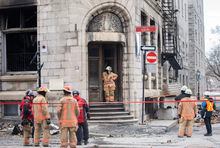 Investigators and firefighters are shown at the scene following a fire in Old Montreal, Saturday, March 18, 2023, that gutted the heritage building.THE CANADIAN PRESS/Graham Hughes 
