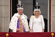 Britain's King Charles III wearing the Imperial state Crown, and Britain's Queen Camilla wearing a modified version of Queen Mary's Crown on the Buckingham Palace balcony while viewing the Royal Air Force fly-past in central London on May 6, 2023, after their coronations. 