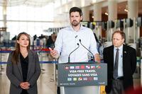 Sean Fraser, Minister of Immigration, Refugees and Citizenship, centre, Rechie Valdez, Member of Parliament for Mississauga, and Kevin Lamoureux, Member of Parliament for Winnipeg North, make an announcement regarding visa-free travel in the Winnipeg airport, Tuesday, June 6, 2023.  THE CANADIAN PRESS/John Woods