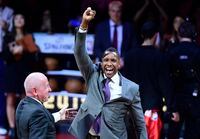FILE - This Oct. 29, 2019,  file photo shows Toronto Raptors president Masai Ujiri reacting after receiving his 2019 NBA basketball championship ring from Larry Tanenbaum, chairman of Maple Leaf Sports & Entertainment, before the Raptors played the New Orleans Pelicans in Toronto. A law enforcement officer in California who sued Ujiri, the president of the Toronto Raptors over a 2019 scuffle following the team's NBA Finals victory over the Golden State Warriors dropped his lawsuit Wednesday, Feb. 10, 2021. (Frank Gunn/The Canadian Press via AP, File)