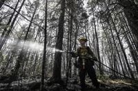 Department of Natural Resources and Renewables firefighter Kalen MacMullin of Sydney, N.S. works on a fire in Shelburne County, N.S. in a Thursday, June 1, 2023 handout photo. THE CANADIAN PRESS/HO-Communications Nova Scotia **MANDATORY CREDIT**