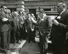 Ray Haynes reads statement supporting convicted longshoremen at Court House, Vancouver, June 17, 1965.  British Columbia Federation of Labour president E.T. Staley, is on right. Credit: Fishermen Publishing Society / University of British Columbia. Library. Rare Books and Special Collections.