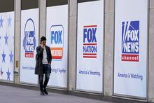 File - A man walks past the News Corp. and Fox News headquarters on April 19, 2023, in New York. Fox News agreed Wednesday, April 26, to hand over reams of documents produced during the just-settled defamation lawsuit between Dominion Voting Machines to another voting technology firm, Smartmatic, which in a $2.7 billion suit accuses the cable news giant of damaging its reputation because of the network’s promotion of lies about the 2020 election. (AP Photo/Mary Altaffer, File)