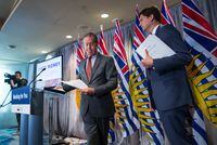 Peter German, left, former deputy commissioner of the RCMP, and B.C. Attorney-General David Eby attend a news conference where they released German's review of anti-money laundering practices in the province, in Vancouver, on June 27, 2018.