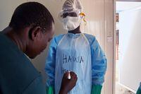 Staff of the International Medical Corps put on personal protective equipment in the isolation ward of the Ministry of Health Infectious Disease Unit, in Juba, South Sudan, on April 24, 2020.