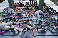Children's shoes adorn a memorial for Saint-Marc-de-Figuery residential school student at the site of the former school near Amos, Canada, November 17, 2021. - Some 150,000 indigenous children were ripped from their families and placed in 139 schools meant to forcibly assimilate them into Canadian "culture" -- in other words, strip them of their native traditions. Thousands of students died, mostly from malnutrition, disease or neglect, in what a truth and reconciliation committee called "cultural genocide" in a 2015 report. Many others were physically or sexually abused. (Photo by Marion THIBAUT / AFP) (Photo by MARION THIBAUT/AFP via Getty Images)