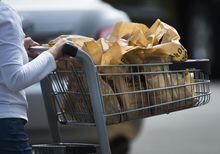 A women leaves a grocery store in Mississauga, Ont., on Thursday, August 15, 2019. A new working draft of the grocery code lays out the fundamental elements of the industry-led accord, which aims to increase "fair and ethical dealing" across the grocery supply chain in Canada.THE CANADIAN PRESS/Nathan Denette