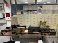 This photo provided by the Los Angeles Police Department shows guns and ammunition that were found in an L.A. apartment. A man who reportedly made violent threats was arrested and investigators found a cache of guns and ammunition in his Hollywood high-rise apartment, where several rifles were pointed at a nearby park, police said Wednesday, Feb. 1, 2023. (Los Angeles Police Department via AP)