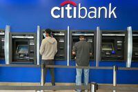 FILE PHOTO: Customers use ATMs at a Citibank branch in the Jackson Heights neighborhood of the Queens borough of New York City, U.S. October 11, 2020. Picture taken October 11, 2020. REUTERS/Nick Zieminski/File Photo