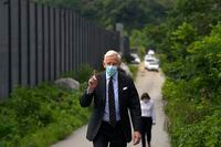 Dominic Barton, Canada Ambassador to China, wearing a face mask gestures after meeting with Canadian Michael Spavor at a detention center in Dandong, China, Wednesday, Aug. 11, 2021. Barton has tendered his resignation after two tense years in the job.THE CANADIAN PRESS/AP-Ng Han Guan