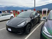 Jason Tchir charges his rented Telsa Model Y in Jasper, Alta. on a drive from Vancouver to Edmonton.