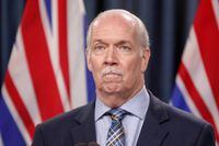 Premier John Horgan answers questions during a news conference in the press theatre at the legislature in Victoria, Friday, March 11, 2022. Horgan says he apologizes for "intemperate comments" he made during a heated question period in British Columbia's legislature. THE CANADIAN PRESS/Chad Hipolito