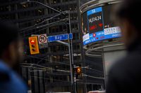 The TSX is shown on a business news ticker is seen in the Financial District in Toronto, Monday, March 9, 2020. The Ontario Securities Commission says it will move toward banning deferred sales charges on mutual funds in the province. THE CANADIAN PRESS/Cole Burston