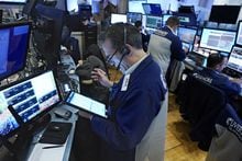 A trader works on the floor of the New York Stock Exchange, Wednesday, Dec. 1, 2021. OMERS says it earned an investment return of 4.2 per cent for 2022 as gains in its private investments helped lift its results even as global stock and bond markets tumbled lower. THE CANADIAN PRESS/AP/Richard Drew
