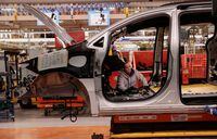 A Stellantis assembly worker works on the interior of a Chrysler Pacifica at the Windsor Assembly Plant in Windsor, Ontario, Canada. January 17, 2023. REUTERS/Rebecca Cook