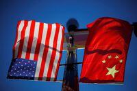 FILE PHOTO: The flags of the United States and China fly from a lamppost in the Chinatown neighborhood of Boston, Massachusetts, U.S., November 1, 2021.   REUTERS/Brian Snyder
