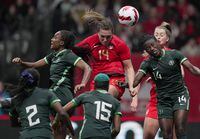 Canada's Vanessa Gilles, centre, vies for the ball against Nigeria's Ifeoma Onumonu, left, and Christy Ucheibe, right, during the second half of a women's friendly soccer match, in Vancouver, on Friday, April 8, 2022. THE CANADIAN PRESS/Darryl Dyck