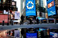 The Nasdaq billboard at Times Square in New York welcomes Coinbase on Wednesday, April 14, 2021, ahead of its stock market debut. Coinbase is the first major cryptocurrency startup to go public on a U.S. stock market. The company’s stock market arrival establishes Bitcoin and other digital currencies in the traditional financial landscape. It also elevates a technology with astonishing environmental costs. (Gabby Jones/The New York Times)