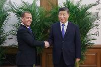 In this photo released by Xinhua News Agency, deputy head of Russia's Security Council and chairman of the United Russia party, Dmitry Medvedev, left, shakes hands with Chinese President Xi Jinping before their meeting in Beijing, Wednesday, Dec. 21, 2022. (Liu Weibing/Xinhua via AP)