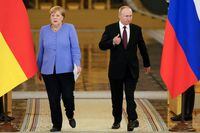Russian President Vladimir Putin and German Chancellor Angela Merkel attend a news conference following their talks at the Kremlin in Moscow, Russia August 20, 2021. Alexander Zemlianichenko/Pool via REUTERS