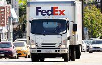 LOS ANGELES, CALIFORNIA - FEBRUARY 01: A FedEx delivery truck is driven by a Fedex employee on February 1, 2023 in Los Angeles, California. FedEx is reportedly laying off over 10 percent of its directors and officers in a move to slash costs amid slower demand from consumers following a pandemic-era surge in e-commerce. (Photo by Mario Tama/Getty Images)