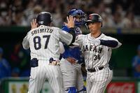 Masataka Yoshida of Japan celebrates with first base coach Masaji Shimzu after hitting a solo home run during the seventh during the seventh inning of the quarterfinal game between Italy and Japan at the World Baseball Classic (WBC) at Tokyo Dome in Tokyo, Japan, Thursday, March 16, 2023. (AP Photo/Toru Hanai)