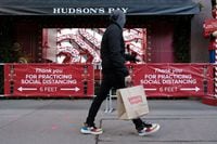 A man walks past a Hudson's Bay store in Toronto, on Nov. 20, 2020.