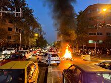 FILE PHOTO: A police motorcycle burns during a protest over the death of Mahsa Amini, a woman who died after being arrested by the Islamic republic's "morality police", in Tehran, Iran September 19, 2022. WANA (West Asia News Agency) via REUTERS