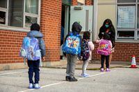 FILE PHOTO: Students arrive for the first time since the start of the coronavirus disease (COVID-19) pandemic at Hunter's Glen Junior Public School, part of the Toronto District School Board (TDSB) in Scarborough, Ontario, Canada September 15, 2020. REUTERS/Carlos Osorio/File Photo