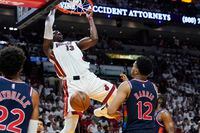 Miami Heat center Bam Adebayo (13) dunks the ball over Philadelphia 76ers forward Tobias Harris (12) during the second half of Game 2 of an NBA basketball second-round playoff series, Wednesday, May 4, 2022, in Miami. (AP Photo/Marta Lavandier)