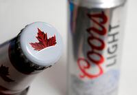 Molson beer, left, and Coors Light beer rest together, in Walpole, Mass. on Nov. 28, 2017. Molson Coors Beverage Company says it is withdrawing its financial outlook for the 2020 financial year and beyond due to uncertainty about the impacts of the ongoing COVID-19 outbreak. THE CANADIAN PRESS/AP, Steven Senne
