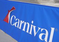 FILE - This Jan. 29, 2021 file photo shows a Carnival Cruise Line sign at PortMiami in Miami. The Belize Tourism Board says 27 people aboard a Carnival cruise tested positive for COVID-19 just before the ship made a stop in Belize City. The positive cases it reported Wednesday, Aug. 12, were among 26 crew members and one passenger on the Carnival Vista, which is carrying over 1,400 crew and nearly 3,000 passengers. (AP Photo/Lynne Sladky, File)