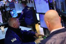 Traders work on the floor of the New York Stock Exchange during morning trading on Dec. 6.