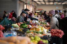 FILE PHOTO: People buy food at a market in Budapest, Hungary, December 3, 2022. REUTERS/Marton Monus