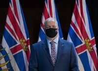 B.C. Premier John Horgan wears a protective face mask to help prevent the spread of COVID-19 before being sworn in during a virtual swearing in ceremony in Victoria, Thursday, November 26, 2020. Premier John Horgan says he's glad he called a provincial election a year ahead of schedule and not just because the New Democrats were re-elected to a majority government. THE CANADIAN PRESS/Jonathan Hayward