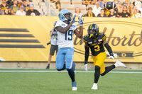 Toronto Argonauts wide receiver Kurleigh Gittens Jr. (19) makes a touchdown catch while defended by Hamilton Tiger-Cats defensive back Tunde Adeleke (2) during first half CFL football game action in Hamilton, Ont. on Friday, July 21, 2023. THE CANADIAN PRESS/Peter Power