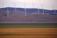 FILE PHOTO: A fence is seen in front of wind turbines that are part of the Infigen Energy Capital Wind Farm located on the hills surrounding Lake George, near the Australian capital city of Canberra, Australia February 21, 2018.  REUTERS/David Gray/File Photo