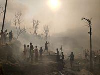 Rohingya refugees try to salvage their belongings after a major fire in their Balukhali camp at Ukhiya in Cox's Bazar district, Bangladesh, Sunday, March 5, 2023. A massive fire raced through a crammed camp of Rohingya refugees in southern Bangladesh on Sunday, leaving thousands homeless, a fire official and the United Nations said. (AP Photo/Mahmud Hossain Opu)