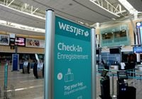 FILE PHOTO: WestJet airline signage is pictured at Vancouver's international airport in Richmond, British Columbia, Canada, February 5, 2019.  REUTERS/Ben Nelms/File Photo