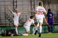 Canada's Evelyne Viens, centre, celebrates with team mates after an own goal, the opening goal by Argentina's goalkeeper Vanina Correa during a women's international friendly soccer match between Canada and Argentina in Sanlucar de Barrameda, Spain, Thursday, Oct. 6, 2022. (AP Photo/Juan Carlos Toro del Rio)